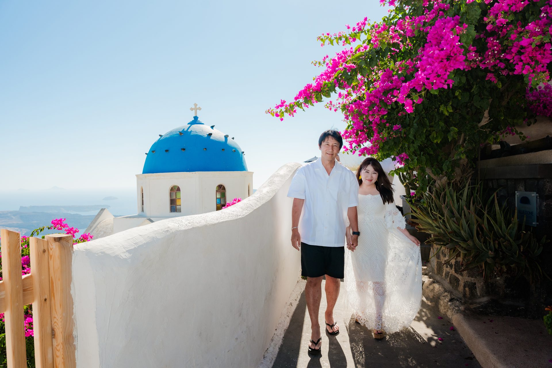 Family photoshoot at the blue-domed church in Oia, Santorini, by family photographer Alexandros Sirigos