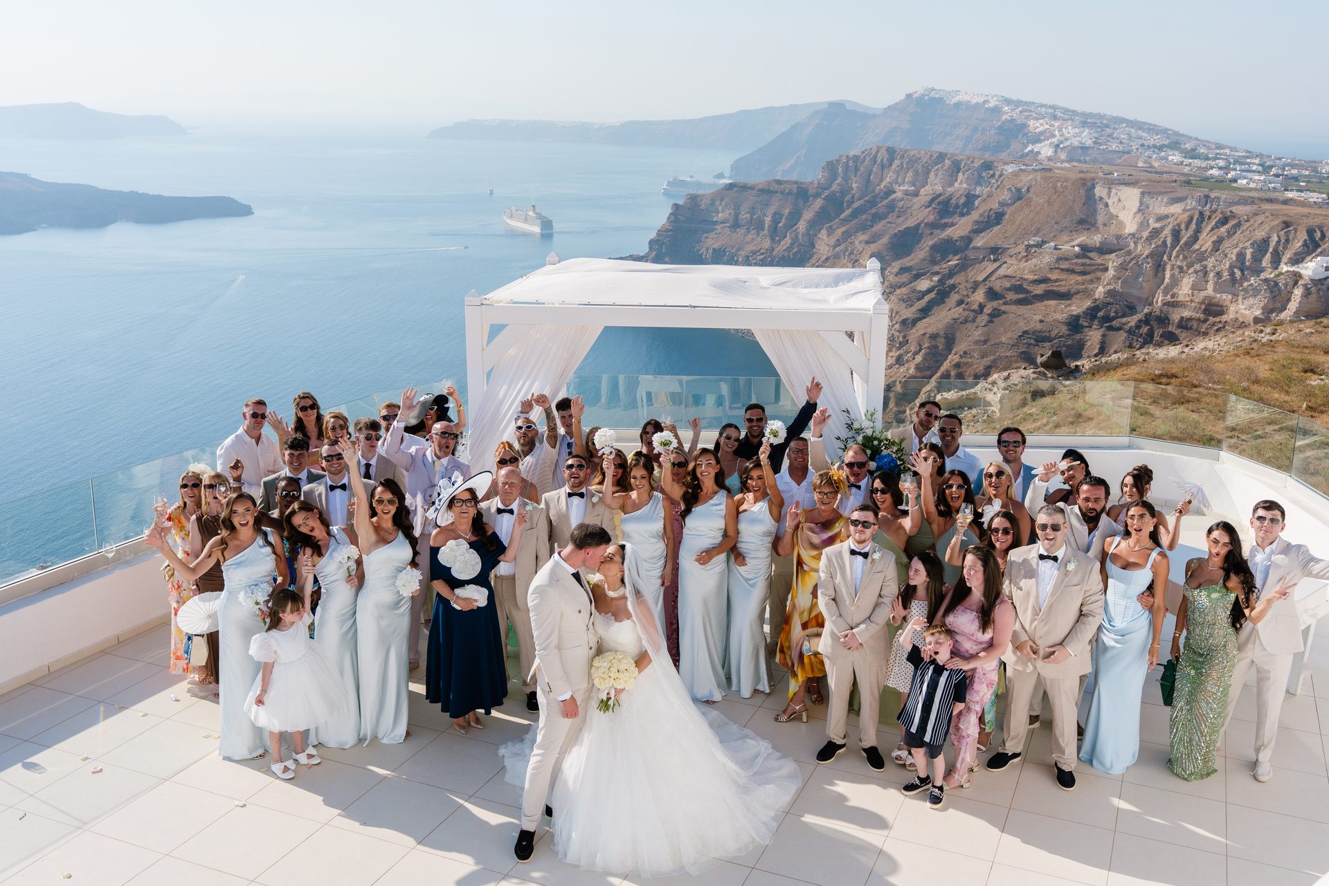 Clifftop wedding ceremony above the Santorini caldera, photographed by wedding photographer Alexandros Sirigos