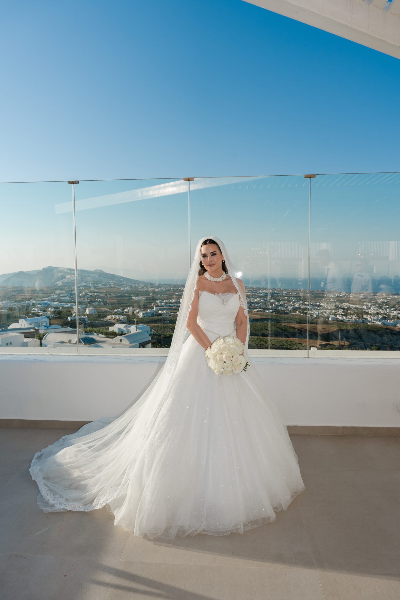 Clifftop wedding ceremony above the Santorini caldera, photographed by wedding photographer Alexandros Sirigos