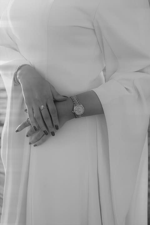 Close-up of the new engagement ring and a watch, hands together on a Santorini catamaran