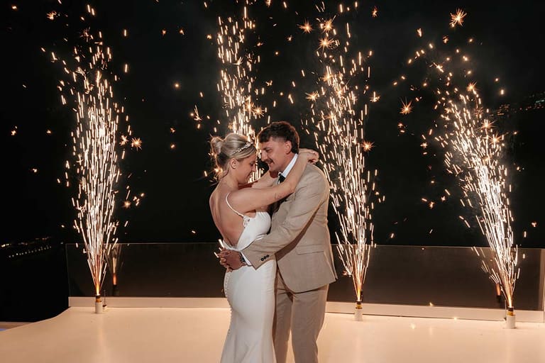 First dance between two sparkler fountains at a caldera wedding venue in Santorini